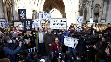 Julian Assange supporters speak to media outside the Royal Courts of Justice in London