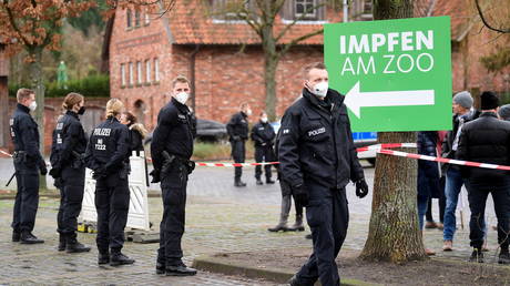 Police officers stand guard outside a coronavirus vaccination center at the zoo in Hanover, Germany on December 17, 2021.