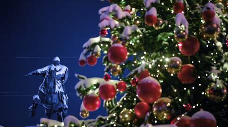 A Christmas tree and a monument to Yuri Dolgoruky at the Moscow Government building in Moscow, Russia.