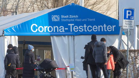People walk past a tent, which is used for COVID-19 tests, at the Stadtspital Triemli hospital in Zurich, Switzerland December 20, 2021