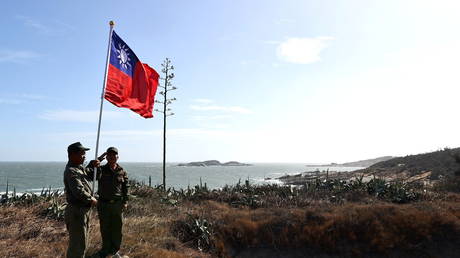 Veterans take part in a flag raising ceremony at a former military post on Kinmen, Taiwan, October 15, 2021