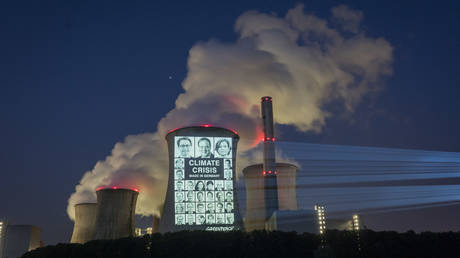 Portraits of 31 German politicians are projected onto a cooling tower of the brown coal power station Neurath in Grevenbroich, July 23.