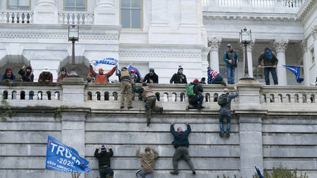 Protesters loyal to then President Donald Trump climb the west wall of the the U.S. Capitol in Washington, Jan. 6, 2021