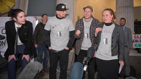 Sage Willoughby, Jake Skuse, Milo Ponsford and Rhian Graham celebrate after receiving a not guilty verdict at Bristol Crown Court, on January 05, 2022 in Bristol, England. © Getty Images / Finnbarr Webster