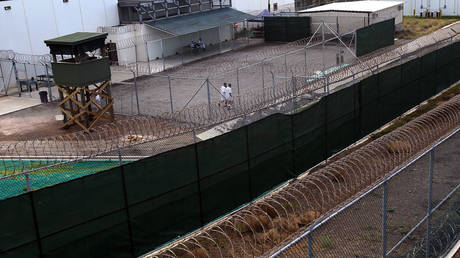Detainees jog inside a recreation yard at Camp 6 in the Guantanamo Bay detention center in Guantanamo Bay, Cuba. © John Moore / Getty Images