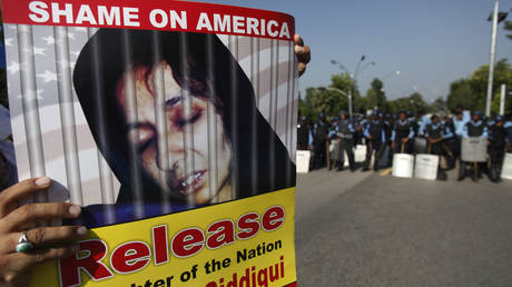 FILE PHOTO: Pakistani police block protesters from proceeding to the U.S. embassy, during a rally in support of Aafia Siddiqui, in Islamabad, Pakistan on Friday, Sept. 24, 2010. © AP Photo/B.K.Bangash