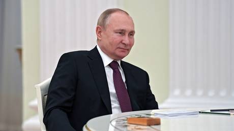 Russian President Vladimir Putin listens to Iranian President Ebrahim Raisi in the Kremlin in Moscow, Russia, Wednesday, Jan. 19, 2022