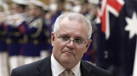 Australian Prime Minister Scott Morrison reviews an honor guard in Tokyo