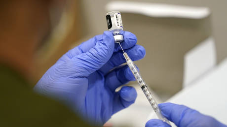 A healthcare worker fills a syringe with the Pfizer COVID-19 vaccine at Jackson Memorial Hospital on Oct. 5, 2021, in Miami