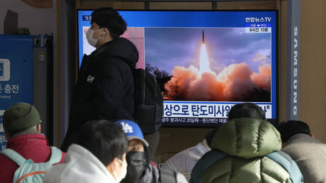People watch a TV showing North Korea's missile launch during a news program at the Seoul Railway Station in Seoul, South Korea, Sunday, Jan. 30, 2022