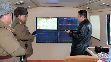 FILE PHOTO. North Korean leader Kim Jong Un (R) speaking with military officials during an observation of a hypersonic missile test-fire conducted by the Academy of Defence Science of the DPRK in North Korea. © AFP / STR