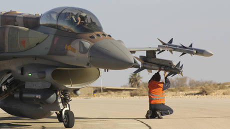 FILE PHOTO: A ground crew member checks an air-to-air missile attached to a Israeli F-16 Sufa fighter jet.