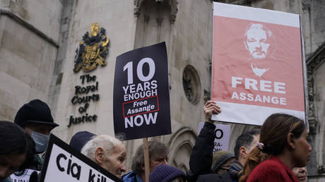 Supporters of Wikileaks founder Julian Assange hold placards, outside the High Court, in London, Monday, Jan. 24, 2022