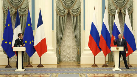 Russian President Vladimir Putin, right, and French President Emmanuel Macron speak after their talks in Moscow, February 7, 2022.