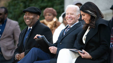 Tulsi Gabbard (right) is shown sitting next to Joe Biden in January 2020, while both were campaigning in South Carolina for the Democrat presidential nomination.