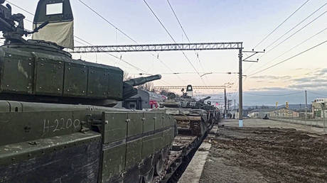 Russian armored vehicles are loaded onto railway platforms after the end of military drills in South Russia.