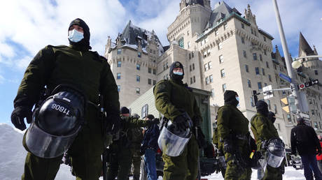 Police begin to break up a protest organized by truck drivers opposing vaccine mandates on February 18, 2022 in Ottawa, Ontario, Canada