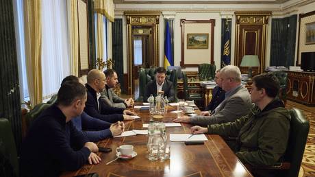 Ukrainian President Volodymyr Zelensky, center, attends an urgent meeting with senior officials after Russia announced a "special military operation," in Kiev, Ukraine, February 24, 2022.