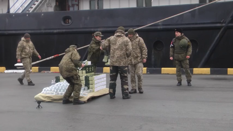 Russian military personnel hand out rations and water to captured Ukrainian border guards at Sevatopol, Crimea, February 26, 2022 © Russian Ministry of Defense