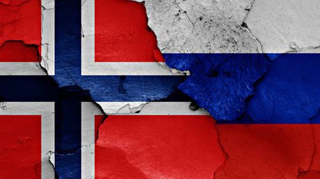 Flags of Norway and Russia painted on cracked wall. © Getty Images