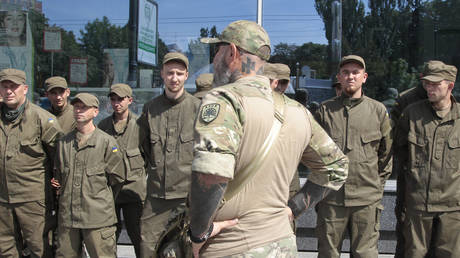 A symbol of Azov volunteer battalion is tattooed on a battalion officer's neck as he talks to his soldiers in Kiev, Ukraine. The battalion's symbol is reminiscent of the Nazi Wolfsangel.