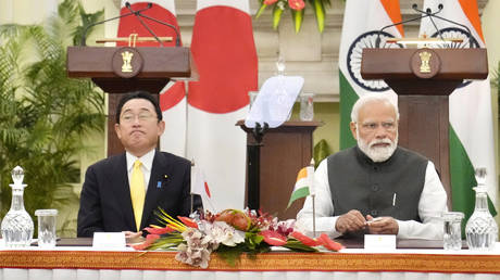Indian Prime Minister Narendra Modi sits his Japanese counterpart Fumio Kishida during a signing of agreements in New Delhi, Saturday, March 19, 2022