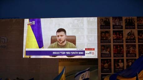 People gather to watch Ukrainian President Volodymyr Zelensky's speech on Knesset via video conference in Tel Aviv, Israel on March 20, 2022.