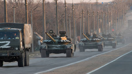 A column of tanks marked with the Z symbol stretches along the Mariupol-Donetsk highway on March 23, 2022.