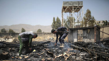 Yemeni police inspect a site of Saudi-led airstrikes targeting two houses in Sanaa, Yemen, Saturday, March 26, 2022. © AP Photo/Hani Mohammed