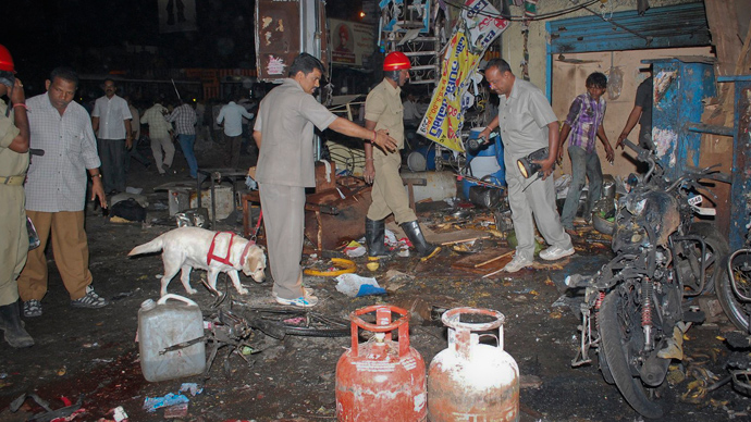 Investigating officers use a sniffer dog as they inspect the site of an explosion at Dilsukh Nagar, in the southern Indian city of Hyderabad February 21, 2013 (Reuters / Stringer)