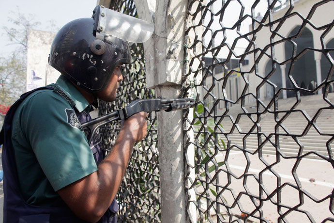 A police officer shoots rubber bullets during a clash with activists from 12 Islamist parties in front of the national mosque in Dhaka February 22, 2013.(Reuters / Andrew Biraj)