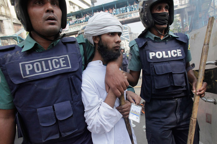 Police arrest an activist from one of the 12 Islamist parties involved in a clash in Dhaka February 22, 2013.(Reuters / Andrew Biraj)