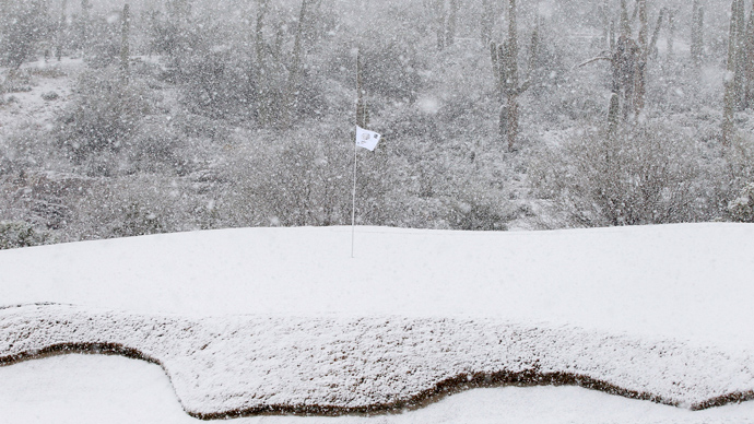 The 18th green is covered in snow as play was suspended during the first round of the WGC-Accenture Match Play Championship golf tournament in Marana, Arizona February 20, 2013 (Reuters / Matt Sullivan)
