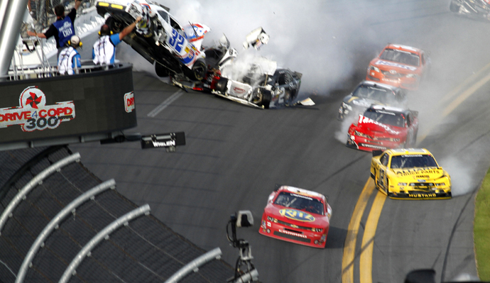 NASCAR driver Tony Stewart avoids a crash to win the NASCAR Nationwide Series DRIVE4COPD 300 race at the Daytona International Speedway in Daytona Beach. (Reuters)