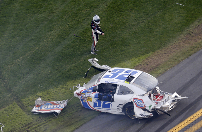 NASCAR driver Kyle Larson's Chevrolet slides on fire down the front stretch on the final lap. (Reuters)