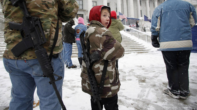 Clint McQueen and his son Chance McQueen, 7, carry rifles at a pro-gun activist rally as part of the National Day of Resistance, at the state Capitol in Salt Lake City, Utah February 23, 2013. (Reuters/Jim Urquhart)