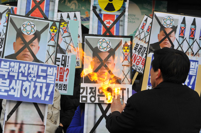 An activists from an anti-North Korea civic group burns a placard of North Korean leader Kim Jong Un during a protest agains North Korean nuclear test in Seoul on February 12, 2013. (AFP Photo/Kim Jae-Hwan)