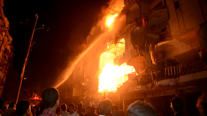 Firefighters spray water to control a fire in a building after a bomb blast in a residential area in Karachi March 3, 2013. A bomb attack in a Shi'ite Muslim area of Pakistan's commercial capital Karachi killed 25 people and wounded 50 on Sunday, the police said (Reuters / Akhtar Soomro)