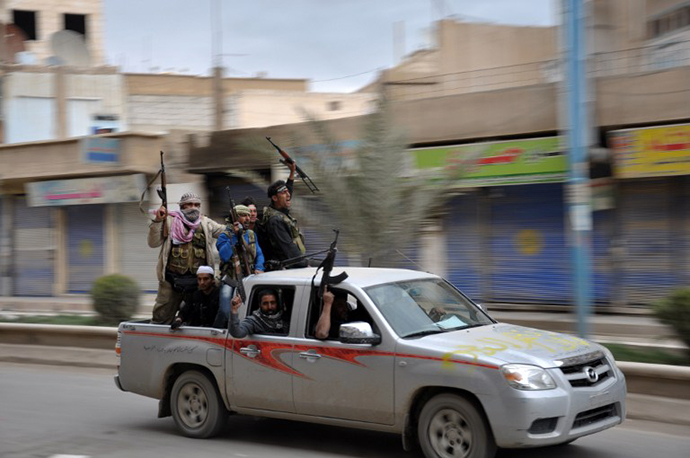 Rebels celebrate in a street in the northern Syrian city of Raqqa after capturing the city on March 4, 2013. (AFP Photo / Mohammad Al-Hussein)