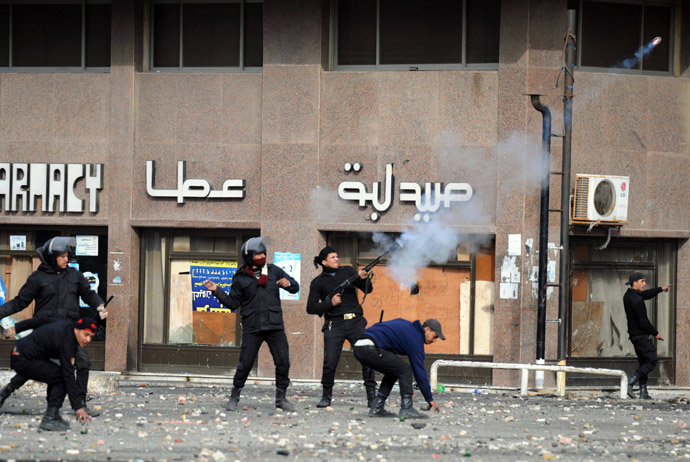 A member of the Egyptian riot police shoots tear gas at protesters during clashes in the Suez Canal city of Port Said on March 7, 2013. (AFP Photo/Jonathan Rashad)