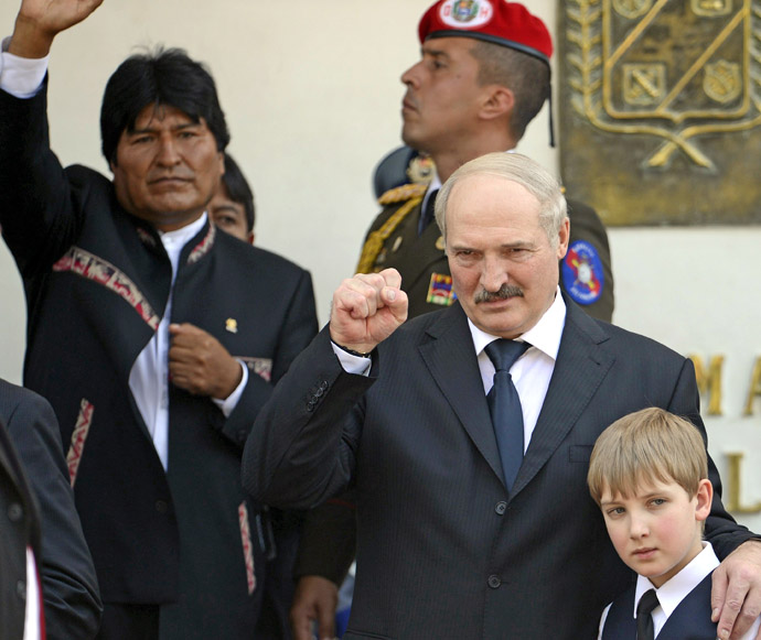 Belarusian President Alexander Lukashenko (R) and his son Nikolai wave next to Bolivian President Evo Morales(L) after the funeral of late Venezuelan President Hugo Chavez in Caracas, on March 8, 2013. (AFP Photo/Juan Barreto)