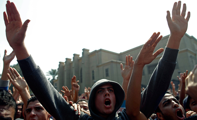 Egyptian al-Ahly football club supporters (Ultras) wave their hands as they celebrate in Cairo on March 9, 2013 (AFP Photo / Mahmud Khaleh)