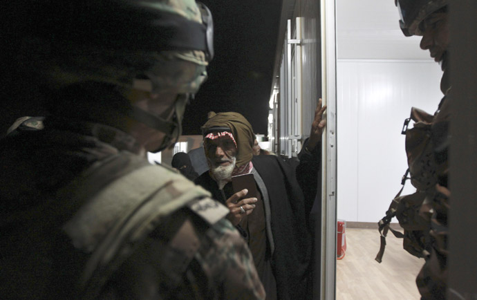 Syrian refugees wait to register their names before they are taken to refugee camps after they crossed the border to Jordan, near Mafraq February 18, 2013. (Reuters/Muhammad Hamed)