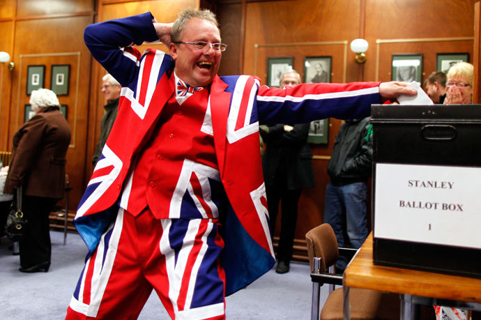 A Falkland Islander gestures as he casts his vote at the Town Hall polling station in Stanley, March 10, 2013 (Reuters / Marcos Brindicci)