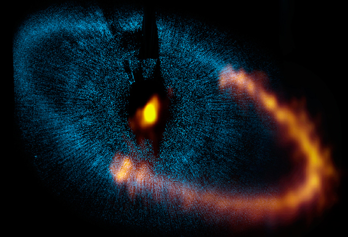 This view shows a new picture of the dust ring around the bright star Fomalhaut obtained by ALMA. The underlying blue picture is an earlier view obtained by the Hubble. Credit: ALMA (ESO/NAOJ/NRAO). Visible light image: the NASA/ESA Hubble Space Telescope