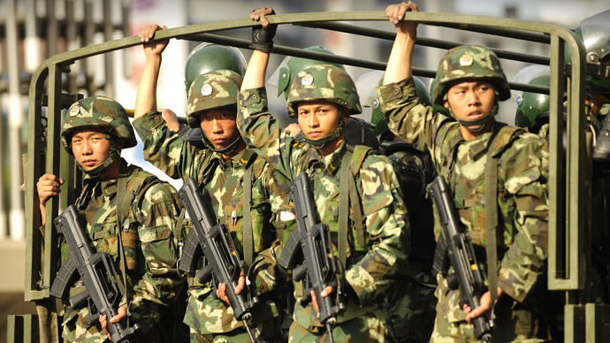 Chinese soldiers in trucks drive on the streets of Urumqi in China's far west Xinjiang province (AFP Photo / Peter Parks)