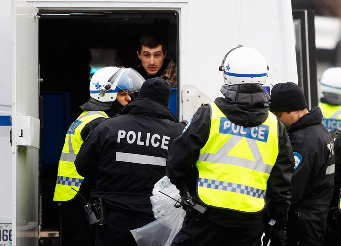 A demonstrator is arrested by police during the annual anti-police brutality march in Montreal, March 15, 2013.(Reuters / Christinne Muschi)