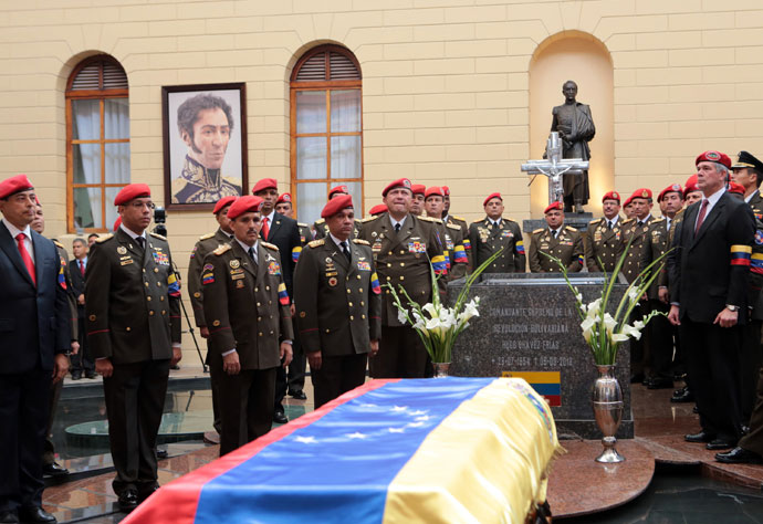 Handout picture released by the Venezuelan presidency showing members of the presidential Honour Guard surrounding the coffin with the remains of late Venezuelan President Hugo Chavez at a temporary resting place at the former "4 de Febrero" barracks -- a barracks-turned-museum that the former paratrooper had used as his headquarters during a failed 1992 coup attempt -- in Caracas, on March 15, 2013.(AFP Photo / Presidencia)