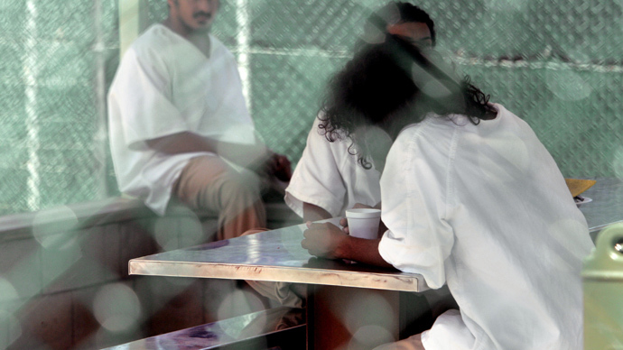 In this photo reviewed by US military officials, detainees, whose names, nationalities, and facial identifications are not permitted, sit within the grounds of Camp Delta 4 military-run prison, at the Guantanamo Bay U.S. Naval Base, Cuba (Reuters / Brennan Linsley / Pool)