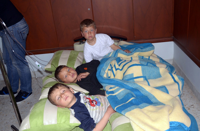 Three boys rest on cushions laid on the floor of a hospital in the Khan al-Assal region in the northern Aleppo province, as Syria's government accused rebel forces of using chemical weapons for the first time on March 19, 2013 (AFP Photo / HO-SANA)